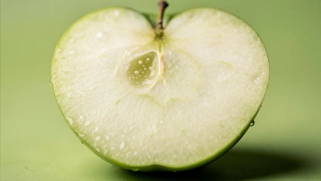Extreme close-up of a green apple slice showing crisp texture and moisture droplets, suggesting its palate-cleansing properties.